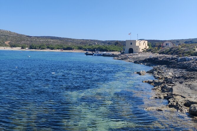 2 hour Private Boat Adventure Tour of Comino and Blue Lagoon - Crystal Lagoon and the cliffs below Saint Mary Tower