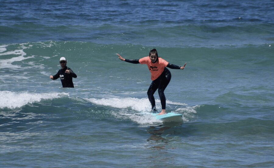Malta Surf School, Beginner Surf Lessons - Moving into chest-high water