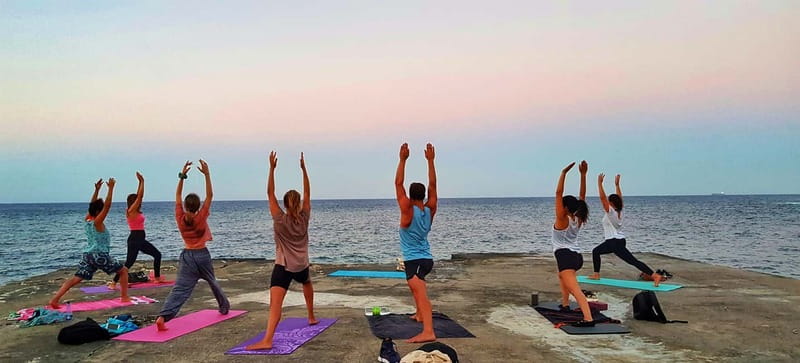 Sliema: Beach Yoga Class with Swimming - Yoga beside the water at Sliema Chalet